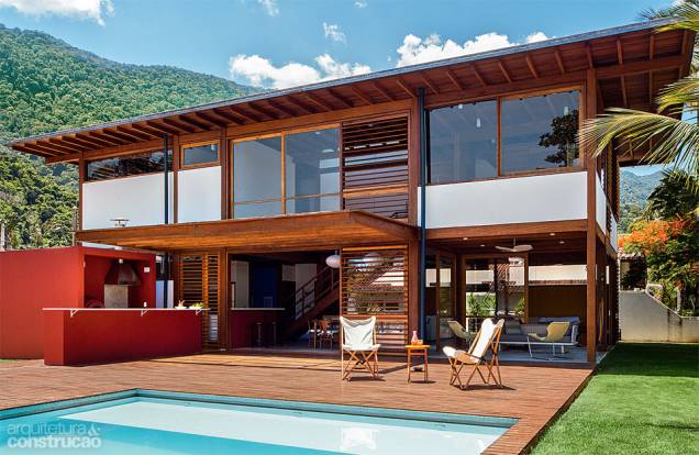 Distante 7 m da borda da piscina (revestida de pastilhas cerâmicas da NGK), a casa não sombreia o tanque durante a tarde. Um prolongamento da bancada da cozinha tornou-se a área gourmet, com churrasqueira e forno de pizza. Projeto do escritório AMZ. Distante 7 m da borda da piscina (revestida de pastilhas cerâmicas da NGK), a casa não sombreia o tanque durante a tarde. Um prolongamento da bancada da cozinha tornou-se a área gourmet, com churrasqueira e forno de pizza. Projeto do escritório AMZ.