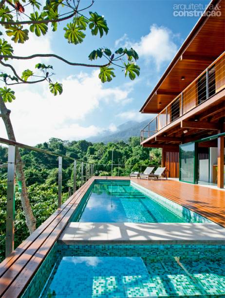 Revestida de pastilhas de vidro (Colormix), a piscina aproveita a face mais privilegiada da casa em termos de paisagem e insolação. Deck de cumaru da Pau-Pau Pisos de Madeira e esquadrias de alumínio da Kiko Esquadrias. Projeto da arquiteta Flávia Cancian.