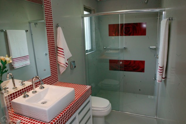 Tons de vermelho marcam o banheiro projetado por Andrea Silva.