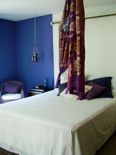 CASA NO INTERIOR DE SP. O dormitório de casal, de 17 m², traz o tema indiano. Um sári foi usado como enfeite para a cabeceira pela arquiteta Rosane Aguiar. O ambiente ainda é integrado com um jardim e banheiro.
