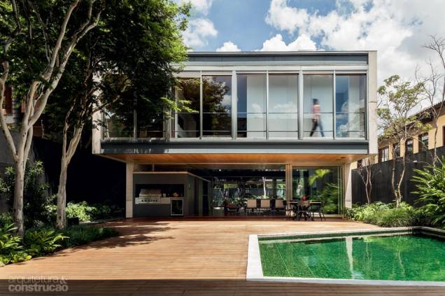 Para posicionar a piscina num ponto sempre ensolarado do jardim, o arquiteto estudou o caminho do Sol nos 365 dias do ano. Revestida de pastilhas de vidro verde-escuro, reflete a vegetação. O deck repete as tábuas de cumaru do interior. Projeto do arquiteto Fernando Viegas. Para posicionar a piscina num ponto sempre ensolarado do jardim, o arquiteto estudou o caminho do Sol nos 365 dias do ano. Revestida de pastilhas de vidro verde-escuro, reflete a vegetação. O deck repete as tábuas de cumaru do interior. Projeto do arquiteto Fernando Viegas.