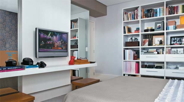 A estante laqueada, de 2,30 x 2,20 m de altura (Ornare), abriga os livros e o...