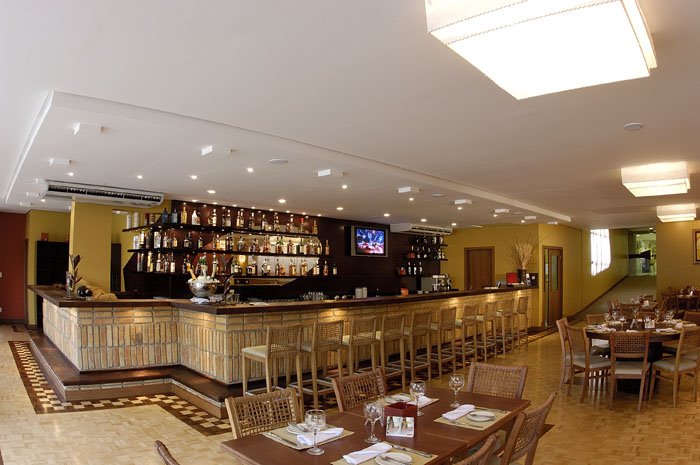 Para fazer o restaurante do hotel Personal Royal, em Caxias do Sul (RS), a arquiteta Melissa Bulla utilizou as referências histórias da cidade de forte tradição italiana. A bancada é feita de tijolos maciços, provenientes da demolição de uma casa da década de 70, remetendo à época colonial. As cadeiras, com trançado no encosto, fazem alusão aos cestos de vime feitos manualmente na região.  Nas paredes, tons de ocre e de terra se revezam, dialogando com os demais elementos do espaço. O projeto é assinado pela arquiteta Melissa Bulla Baron.