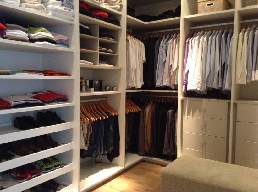 A praticidade dá a tônica deste closet distribuído ao longo dos 11 m² do espaço. Isso porque a disposição dos nichos, gavetas e o próprio material, MDF na cor linho fendi, foram escolhidos pensando na facilidade de limpeza e durabilidade. Feito para um casal jovem, moradores de Barueri (SP), o closet tem iluminação direcionada ao abrir as gavetas -- isso ajuda a ver melhor as peças guardadas. “Nas sapateiras, também foram instaladas lâmpadas PAR 20 e, ao centro, foram colocadas lâmpadas econômicas”, explica a designer de interiores Renata Gonzalez, que assina o projeto.