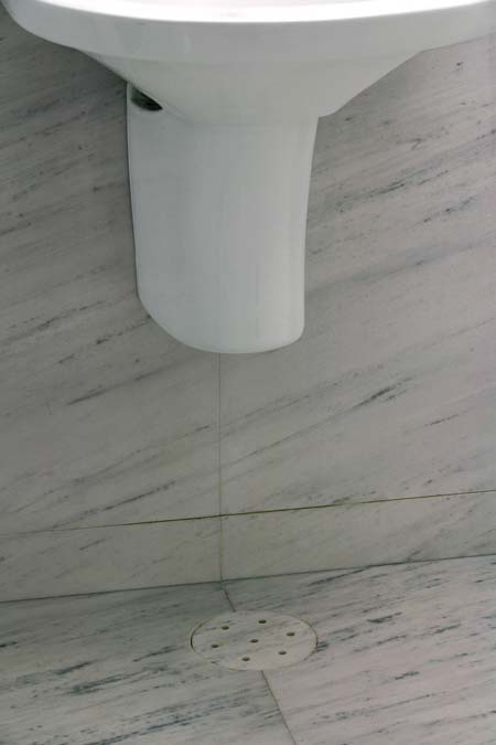 Nos banheiros, mais precisão: os veios das placas de mármore branco piguês...