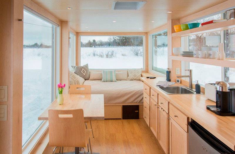 Esta pequena cozinha faz parte de um trailer da companhia ESCAPE Homes, especial para uso como ref&uacute;gio. A estrutura longa junta dormir, com um grande colch&atilde;o, estar e jantar em uma mesa, pequena cozinha e muito espa&ccedil;o para guardar objetos. Tudo em 14 metros quadrados!