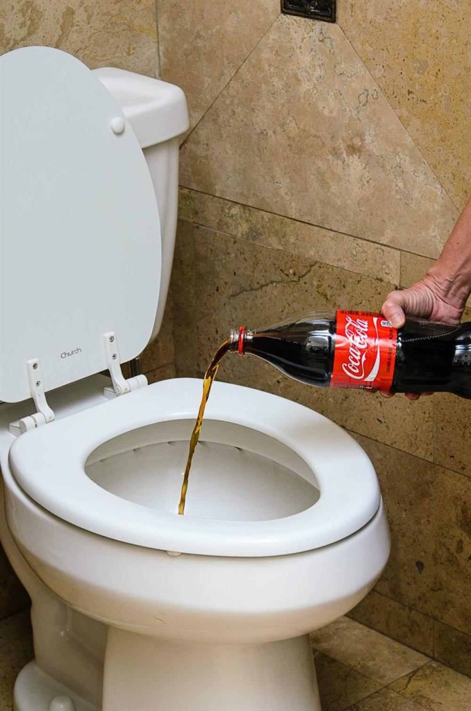 Como desentupir vaso sanitário: 7 formas de resolver o problema. Pessoa jogando coca cola no vaso.