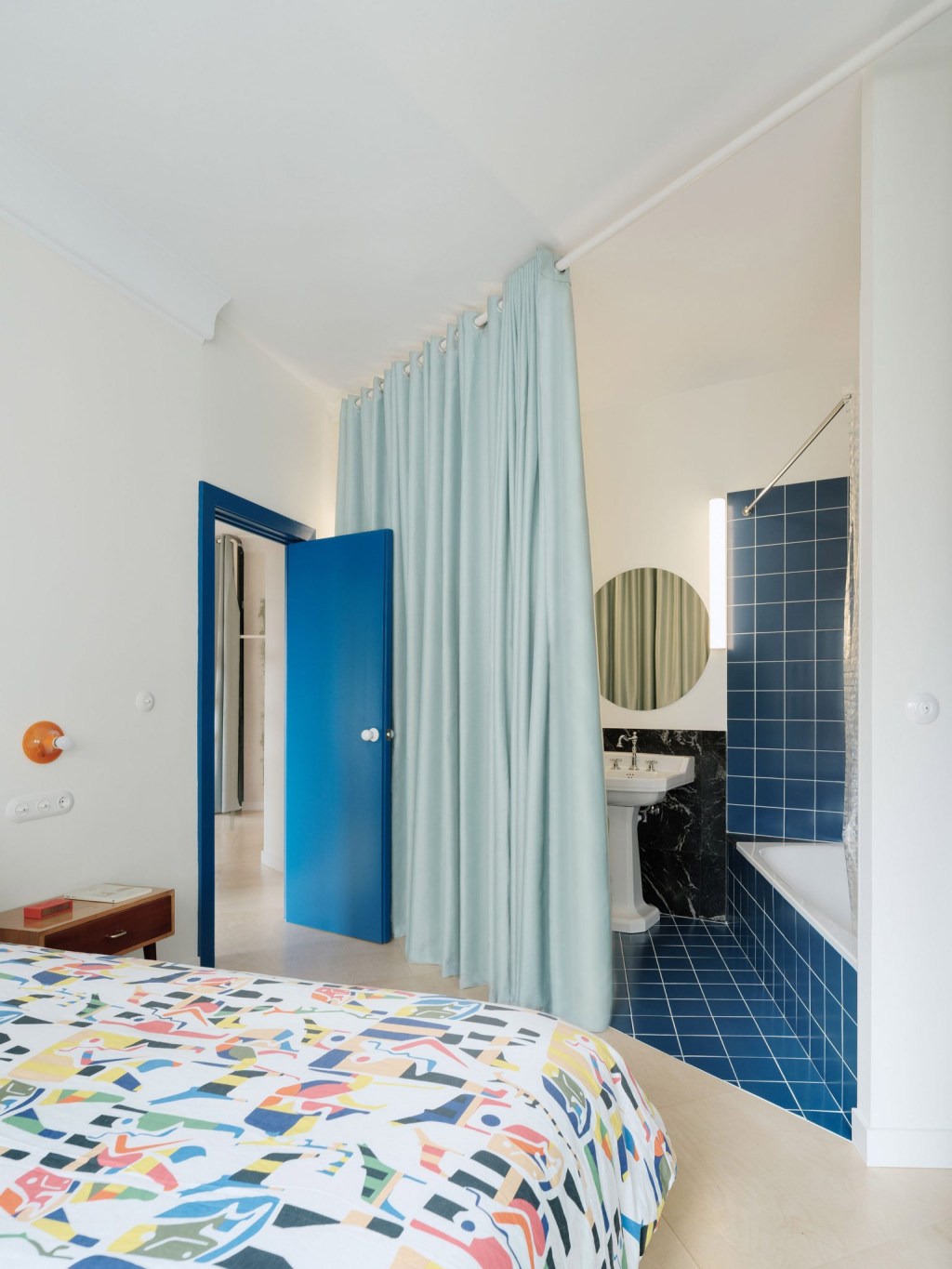 Banheiro integrado à quarto com ladrilhos azuis