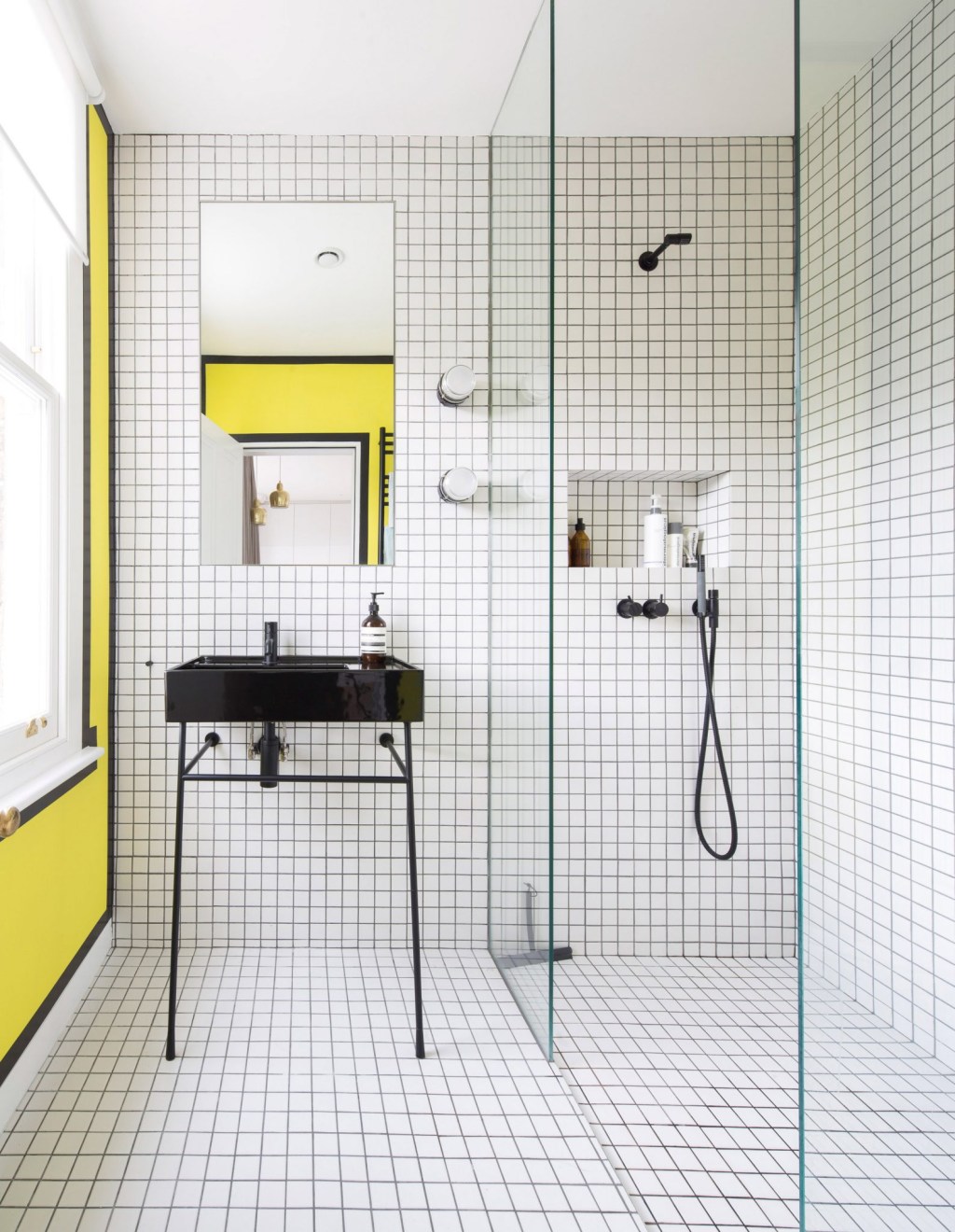 Banheiro com ladrilhos brancos e detalhes amarelos