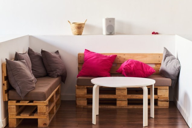 Wooden pallet sofas with colorful pillows.