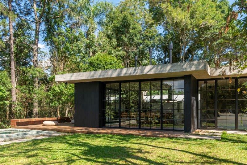 Casa de campo de 195 m² é um refúgio que se camufla entre as árvores