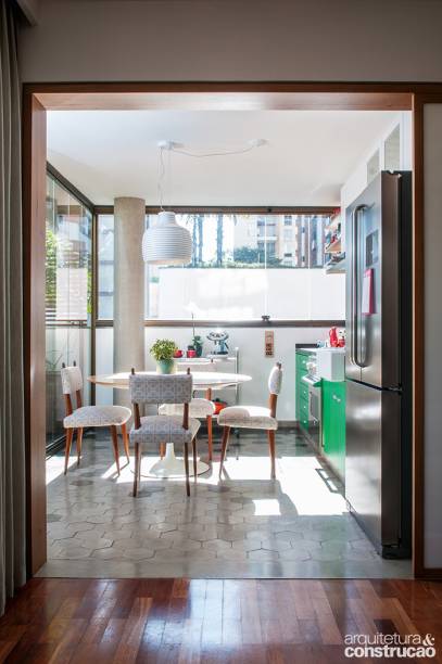Para transformar o espaço da varanda em uma cozinha, este projeto exigiu uma pequena obra além da troca de revestimentos, começando pela tubulação. O sistema hidráulico conectou-se ao ponto de água da churrasqueira antes existente, removida na reforma. Tudo isso feito sob a laje, pelo forro do andar de baixo, área comum do prédio. Já a parte elétrica foi puxada do quarto situado bem ao lado na planta.
