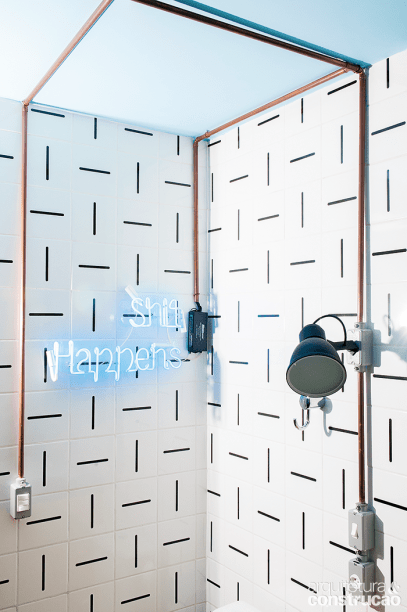 No trecho da ducha, destaque para a tubulação de cobre aparente. Azulejos da Lurca e luminárias da Reka.