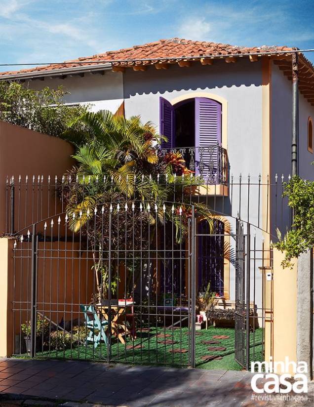 Nada de carros na garagem! Palmeiras e plantinhas em vasos, além de mesa, cadeiras e bancos feitos de paletes, marcam a frente (3 m de largura) deste refúgio urbano. A grama, verdinha assim, é sintética, mas não diminui o encanto da casa, singular por sua combinação de cores: a superfície maior leva uma mistura de tinta branca e corante Xadrez preto (da Sherwin-Williams); as molduras das esquadrias e a quina da construção, tinta acrílica amarela temperada com corante Xadrez vermelho; e as grades das janelas e a veneziana da porta-balcão do terraço, esmalte Ipê-roxo (ref. E088, da Suvinil). O telhado de peças coloniais é compartilhado com a casa ao lado. Nada de carros na garagem! Palmeiras e plantinhas em vasos, além de mesa, cadeiras e bancos feitos de paletes, marcam a frente (3 m de largura) deste refúgio urbano. A grama, verdinha assim, é sintética, mas não diminui o encanto da casa, singular por sua combinação de cores: a superfície maior leva uma mistura de tinta branca e corante Xadrez preto (da Sherwin-Williams); as molduras das esquadrias e a quina da construção, tinta acrílica amarela temperada com corante Xadrez vermelho; e as grades das janelas e a veneziana da porta-balcão do terraço, esmalte Ipê-roxo (ref. E088, da Suvinil). O telhado de peças coloniais é compartilhado com a casa ao lado.