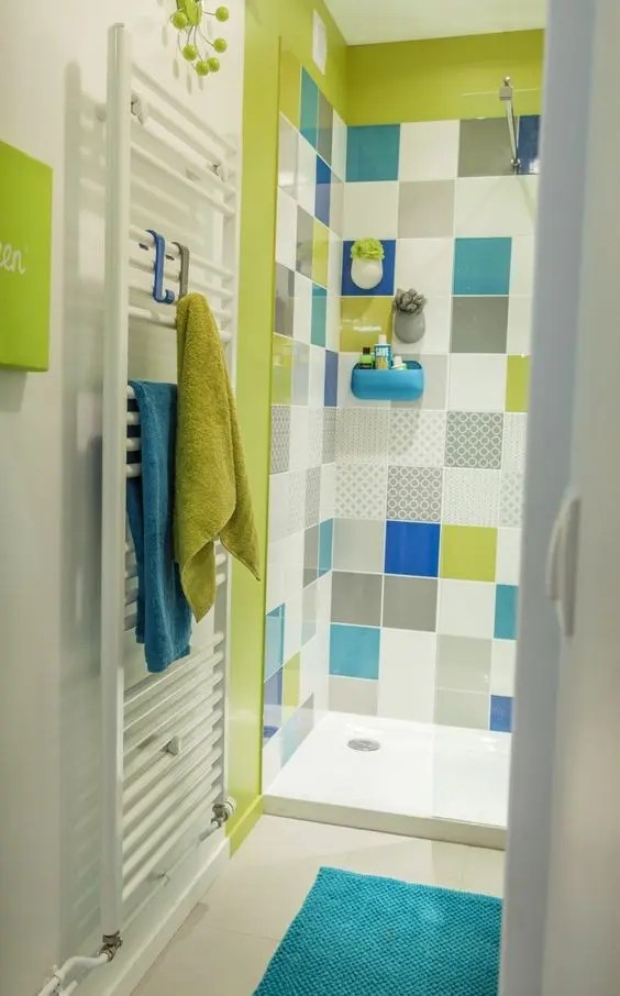 Uma cabine de banho verde neon combina com azulejos multicoloridos
