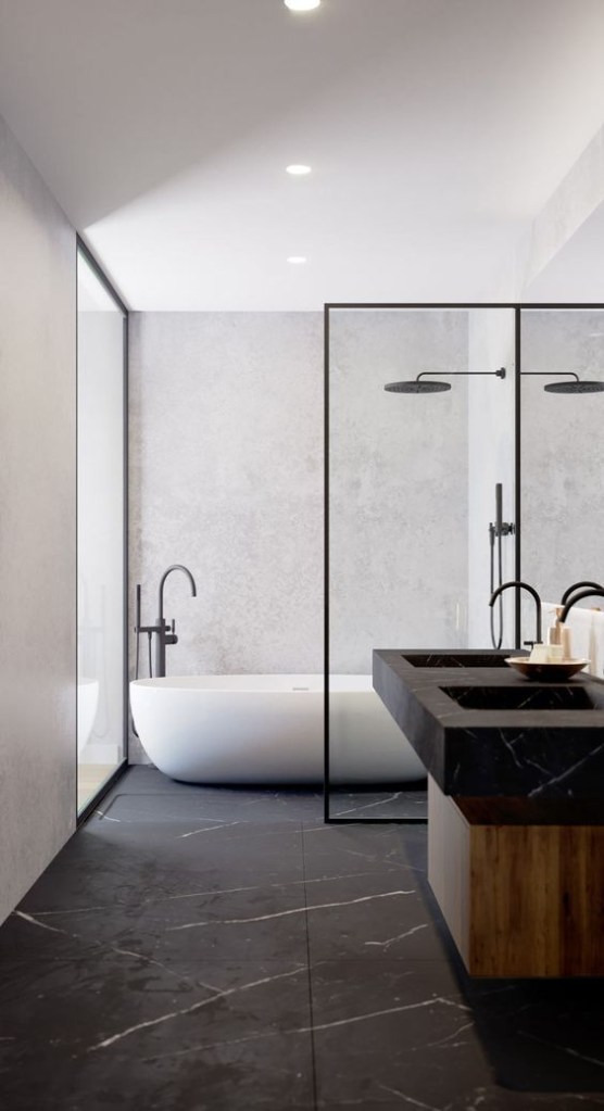 Banheiro com minimalista com bancada de madeira escura coberta por cuba retangular preta. O piso é em cinza escuro e as paredes e teto brancos. Ao fundo, uma banheira branca de forma sinuosa simples.
