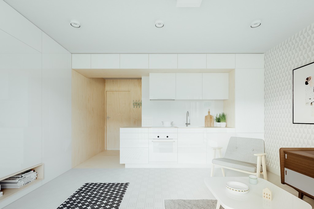 Cozinha e sala de estar integradas. Pareces e móveis em cores claras.