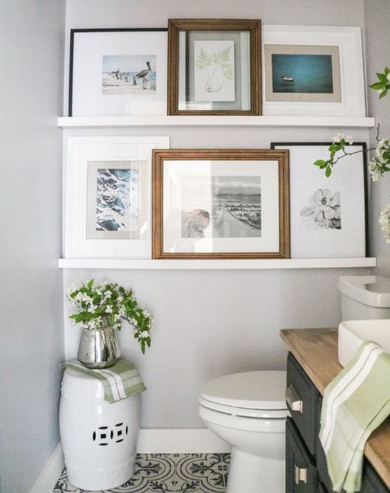easide-artwork-a-grey-vanity-with-a-butcherblock-countertop-white-appliances Banheiro com uma parede repleta de quadros.