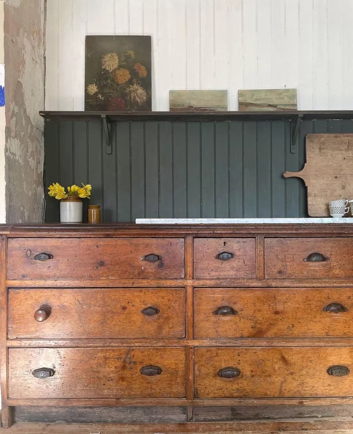 Cozinha com backsplash em painel de madeira verde.