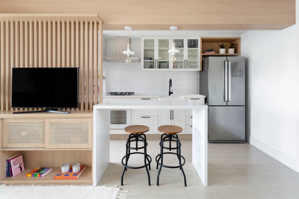 Sala integrada à cozinha com painel ripado de TV