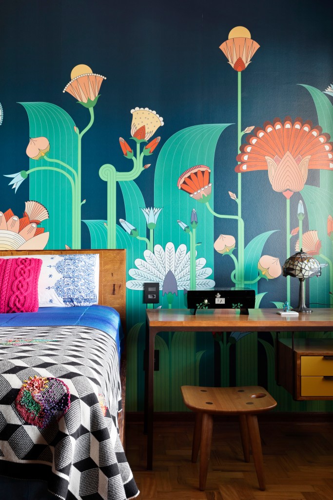 Quarto com cama e paredes com desenhos florais