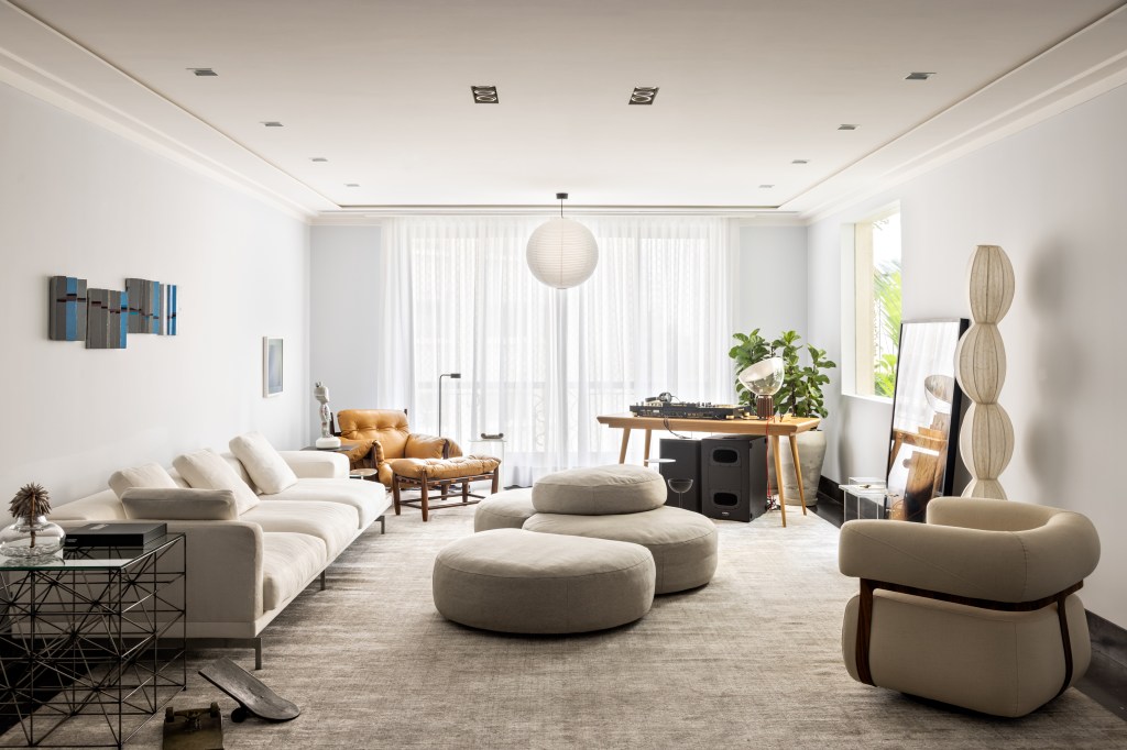Sala de estar; pufes no centro; sofá branco; poltrona branca; poltrona Mole de Sergio Rodrigues