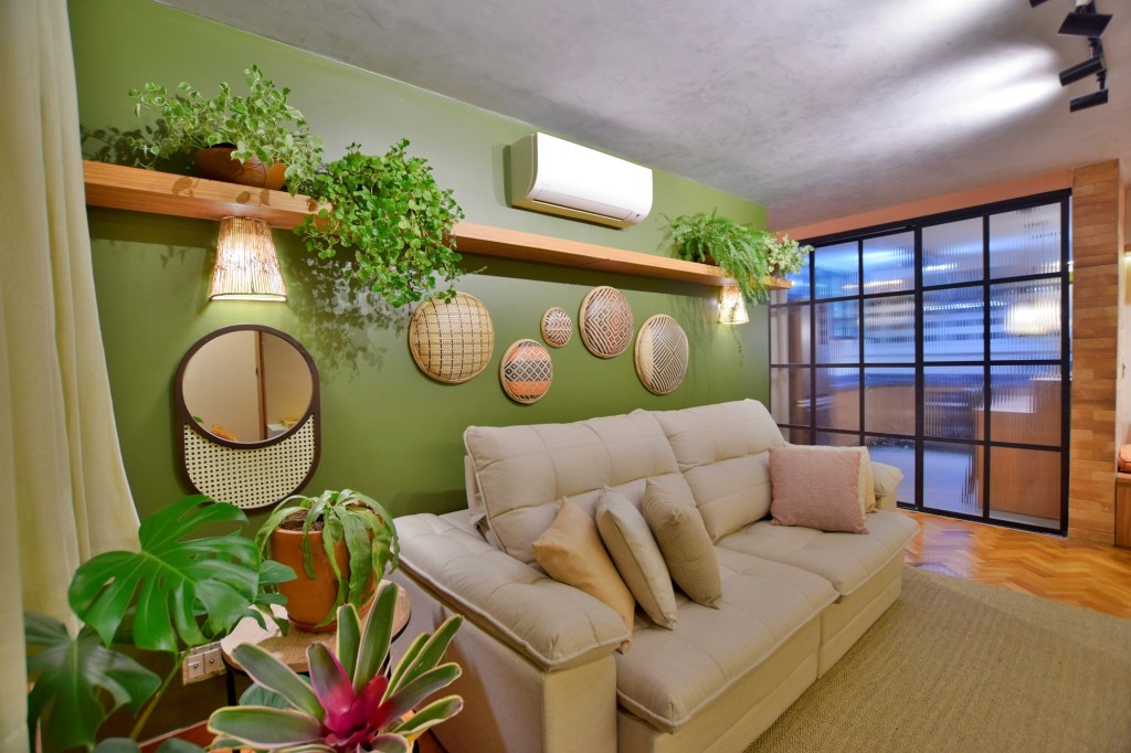 3 jeitos fáceis de usar materiais naturais na decoração; Na foto, sala de estar; plantas; sofá branco; parede verde