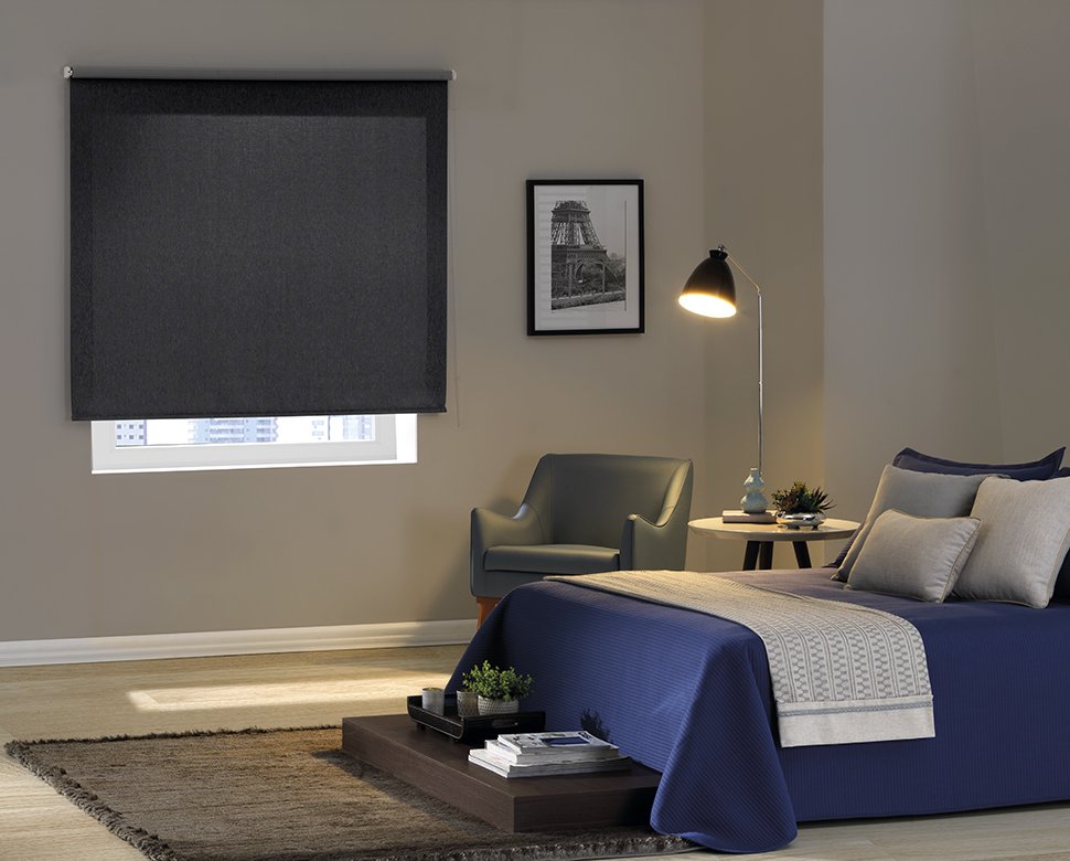 Quarto com cortina tipo rolo blackout.