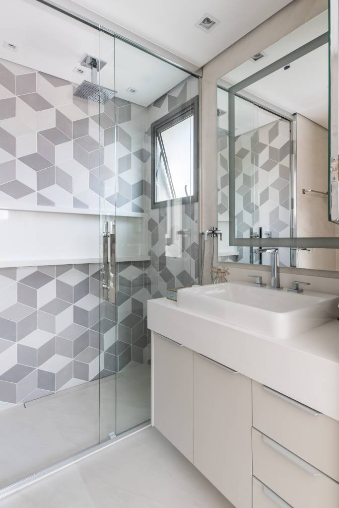 iluminacao-led-elegancia-sobria-ape-95m-bma-studio-22-banheiro Banheiro com box de vidro e parede de azulejos geométricos brancos e cinzas.