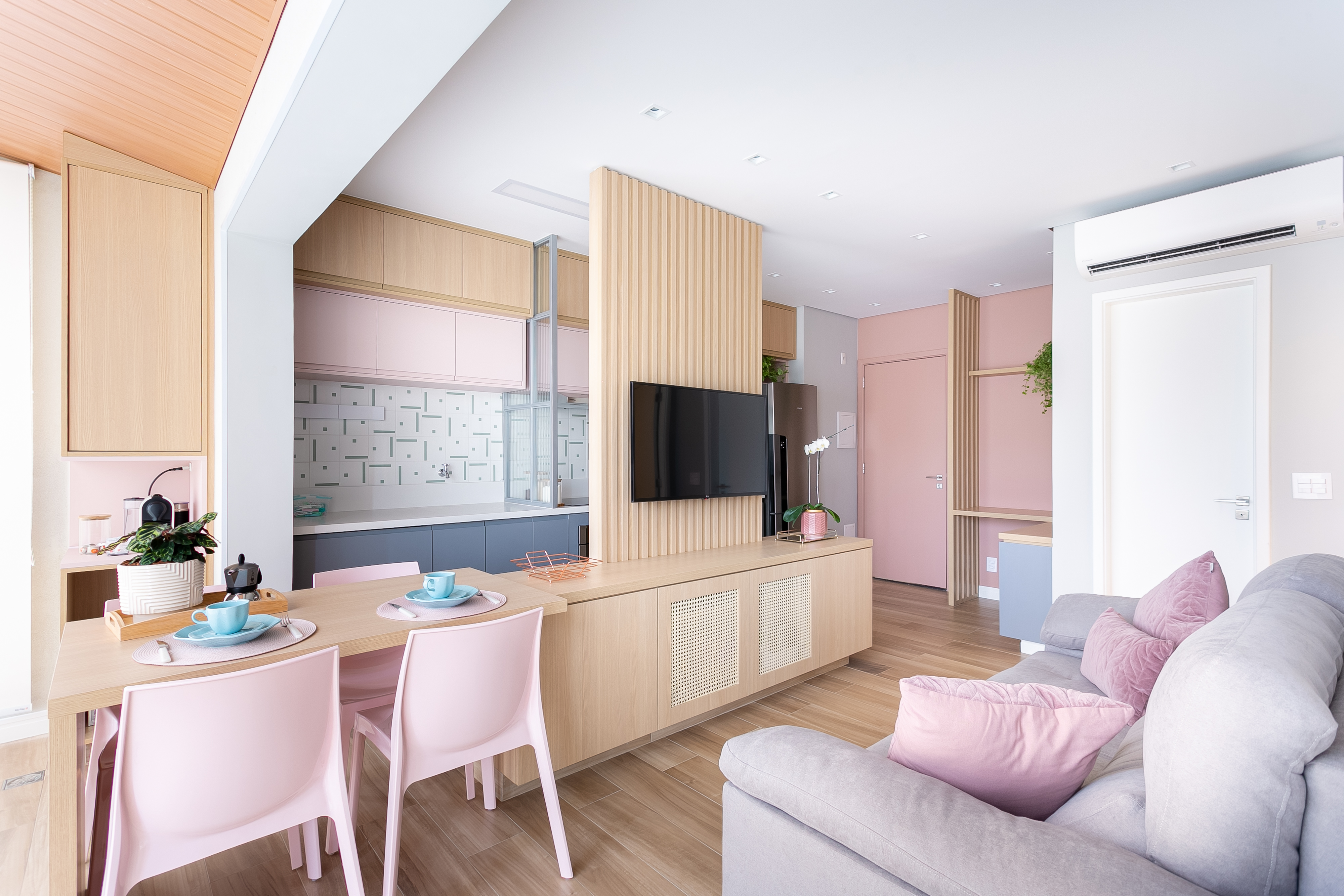 Mesa cozinha estende varanda apê 47 m2 Loft 7 Arquitetura apartamento pequeno decoração sala cozinha painel madeira rosa cinza tv madeira