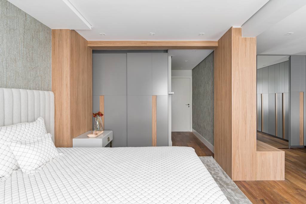 Quarto claro com cama de casal e closet integrado com marcenaria cinza