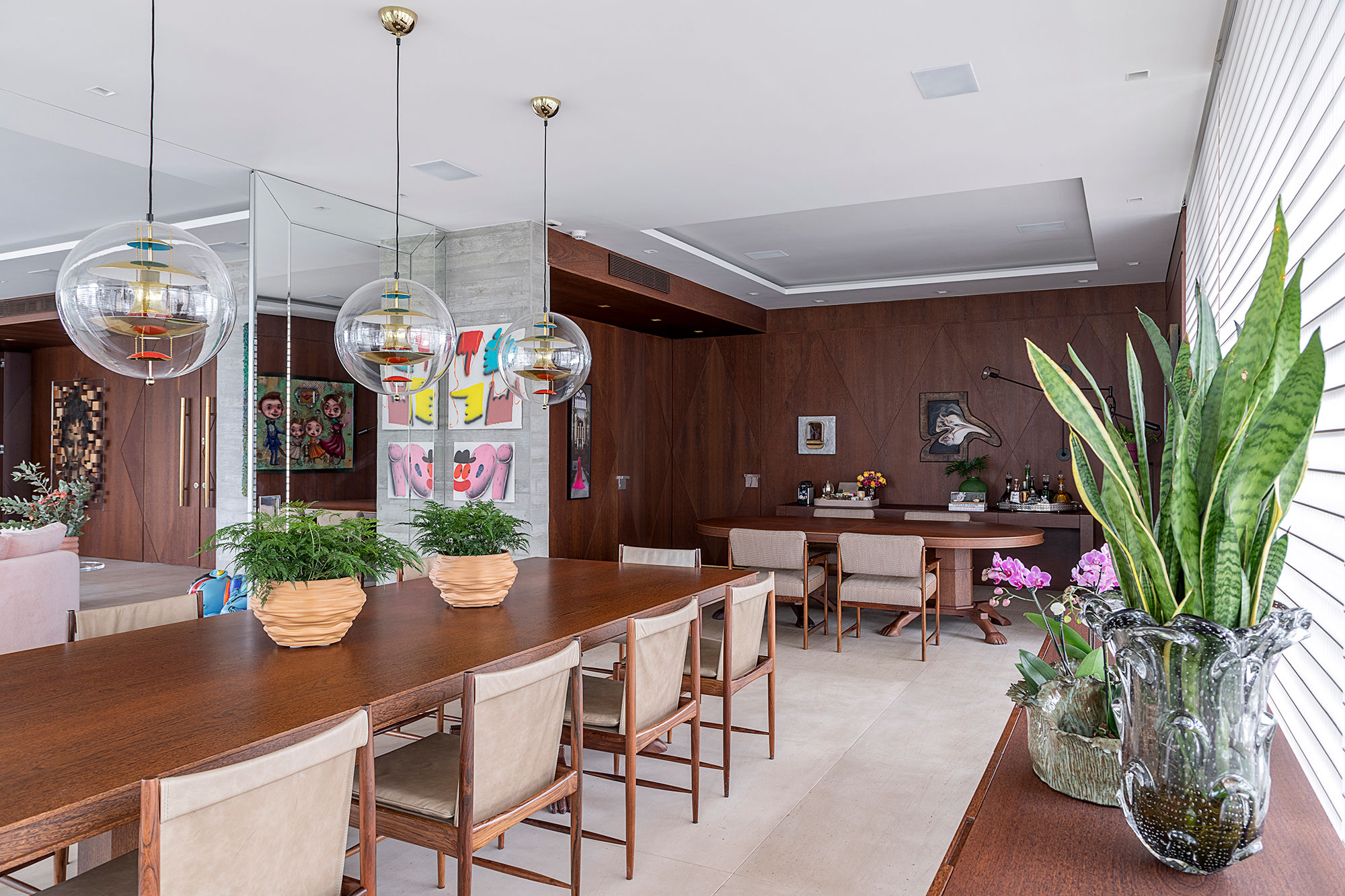 Apê descolado de 632 m² tem sofás coloridos e adega para mil garrafas. Projeto de Ana Weege. Na foto, varanda gourmet com persianas e pendentes, Sala de jantar com parede de madeira.