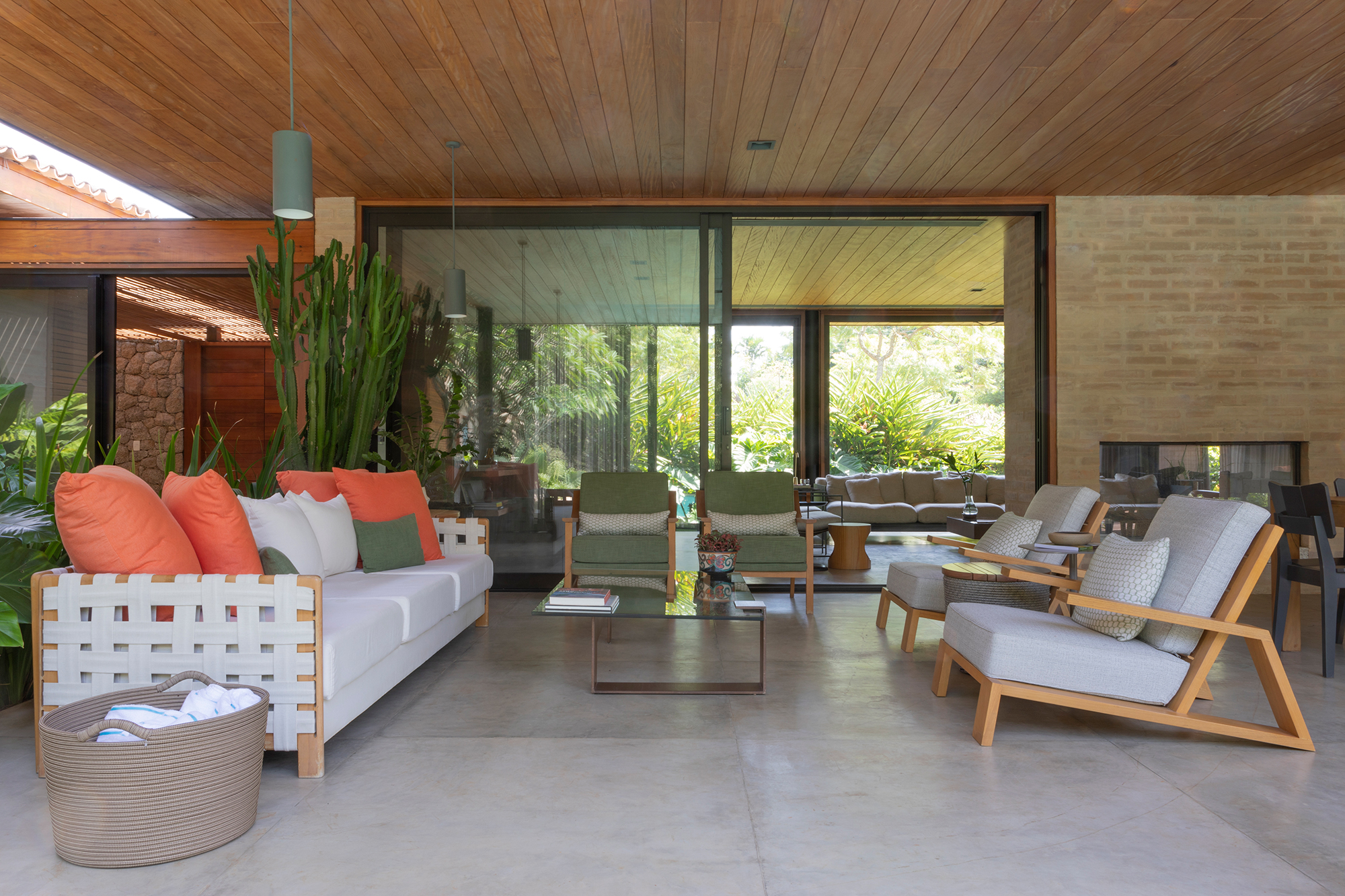 Casa de campo de 818 m² é um verdadeiro refúgio em meio à natureza. Projeto de Daniel Fromer. Na foto, varanda com poltronas e sofá.