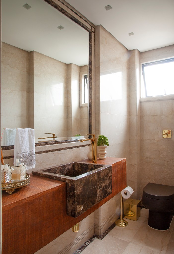 Projeto de Carina Dal Fabbro. Na foto, lavabo com bancada de madeira de demolição e cuba marmorizada.