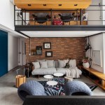 Tijolinhos revestem loft de 100m² industrial com home office no mezanino