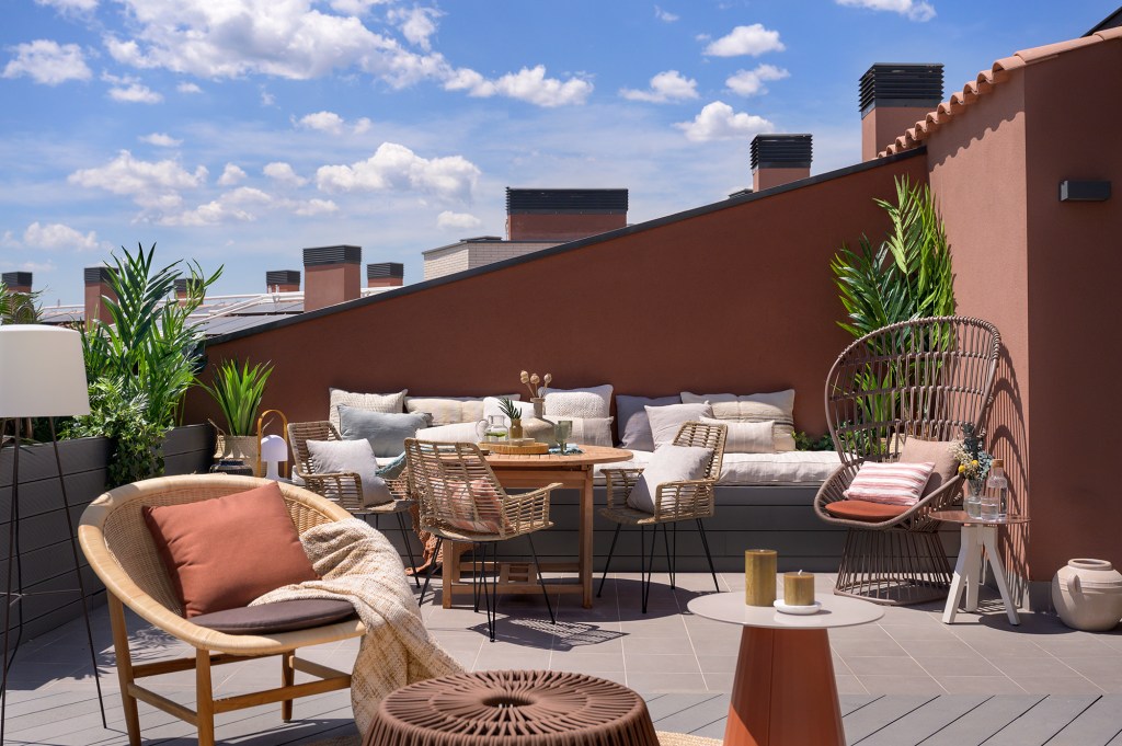 Terraço de dúplex de 192 m² em Barcelona é uma verdadeira sala nas alturas. Projeto de Egue y Seta. Na foto, terraço com estar com poltrona e plantas.