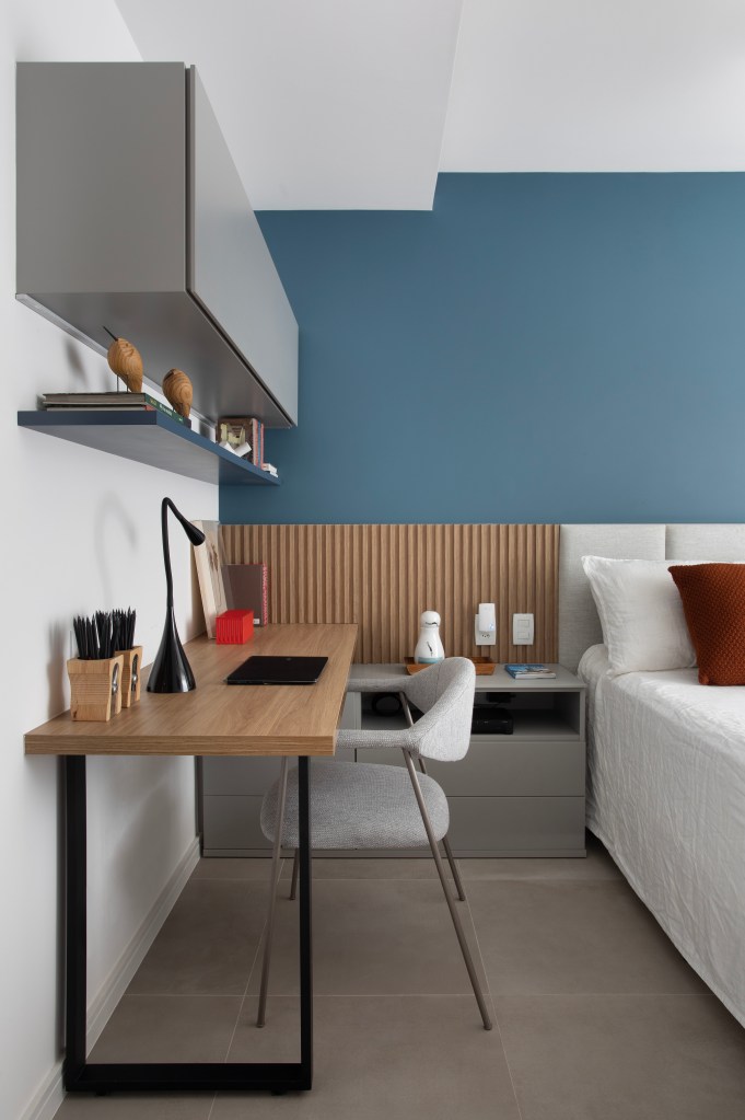 Cozinha com armário verde laqueado e bancada de granito é destaque em apê. Projeto de Ao Quadrado Arquitetura. Na foto, quarto com home office e parede azul.