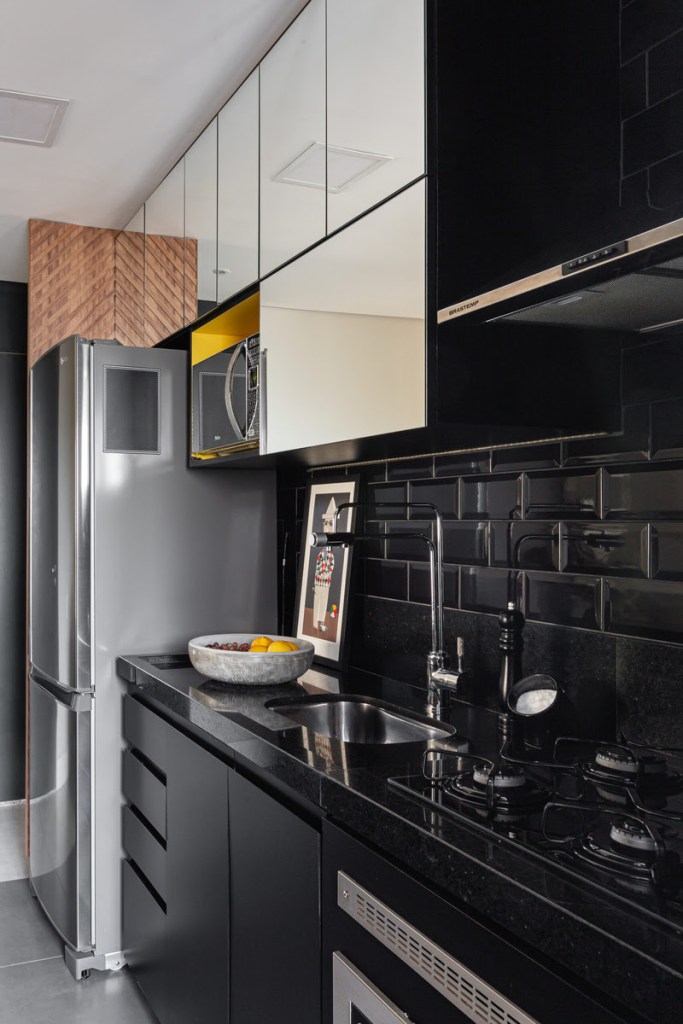 Confira 4 ideias de cores para marcenaria de cozinhas para te inspirar. Projeto de Natalia Salla. Na foto, cozinha com marcenaria preta.