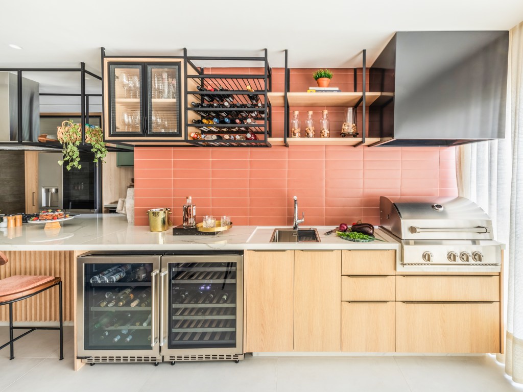 Ambientes Peach Fuzz. Projeto de BMA Studio. Na foto, cozinha com parede de azulejos na cor peach fuzz.