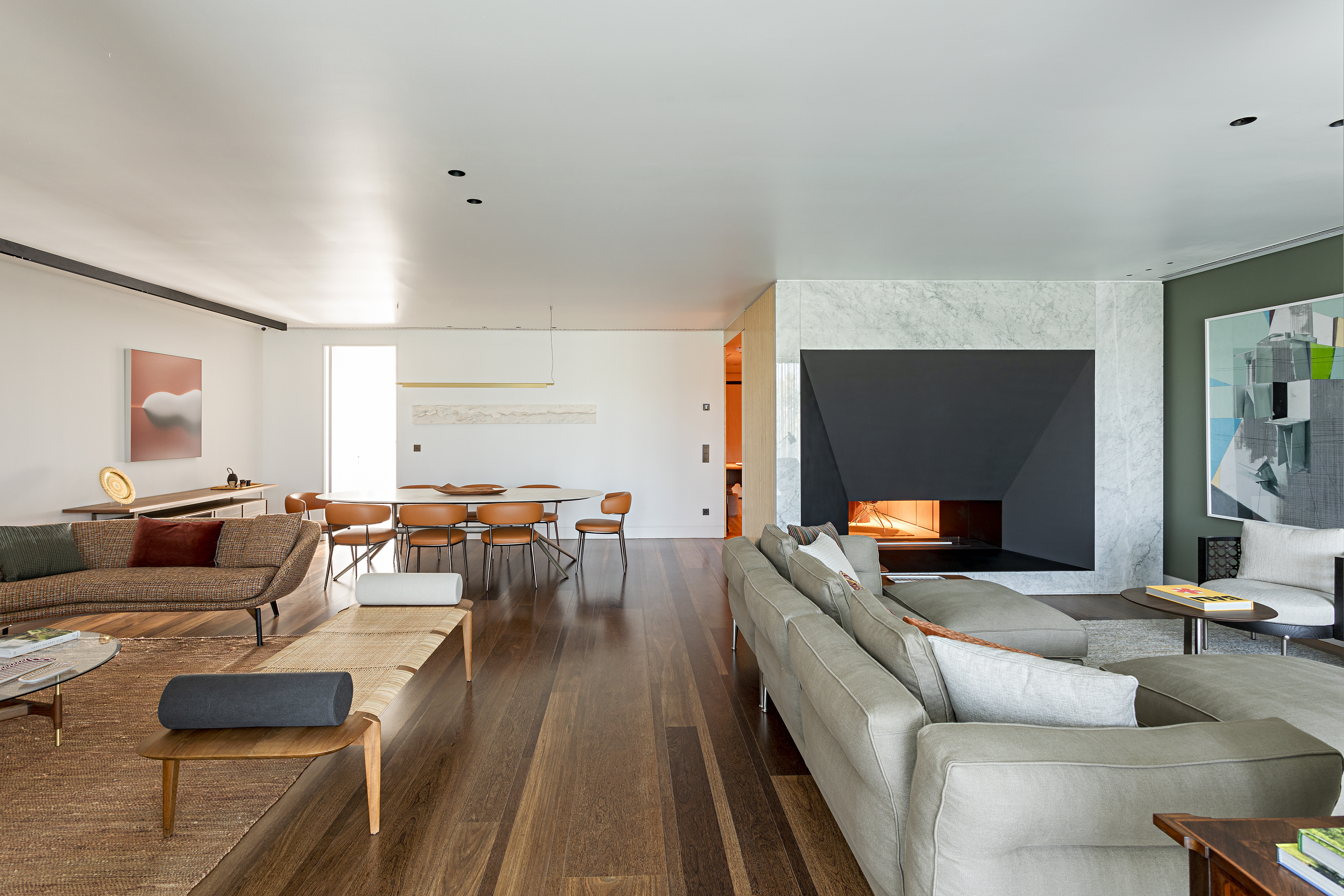 Mix entre antigo e moderno com diferentes culturas define apê de 290 m². Projeto de Andrea Chicharo Arquitetura. Na foto, sala integrada, piso de madeira, banco.