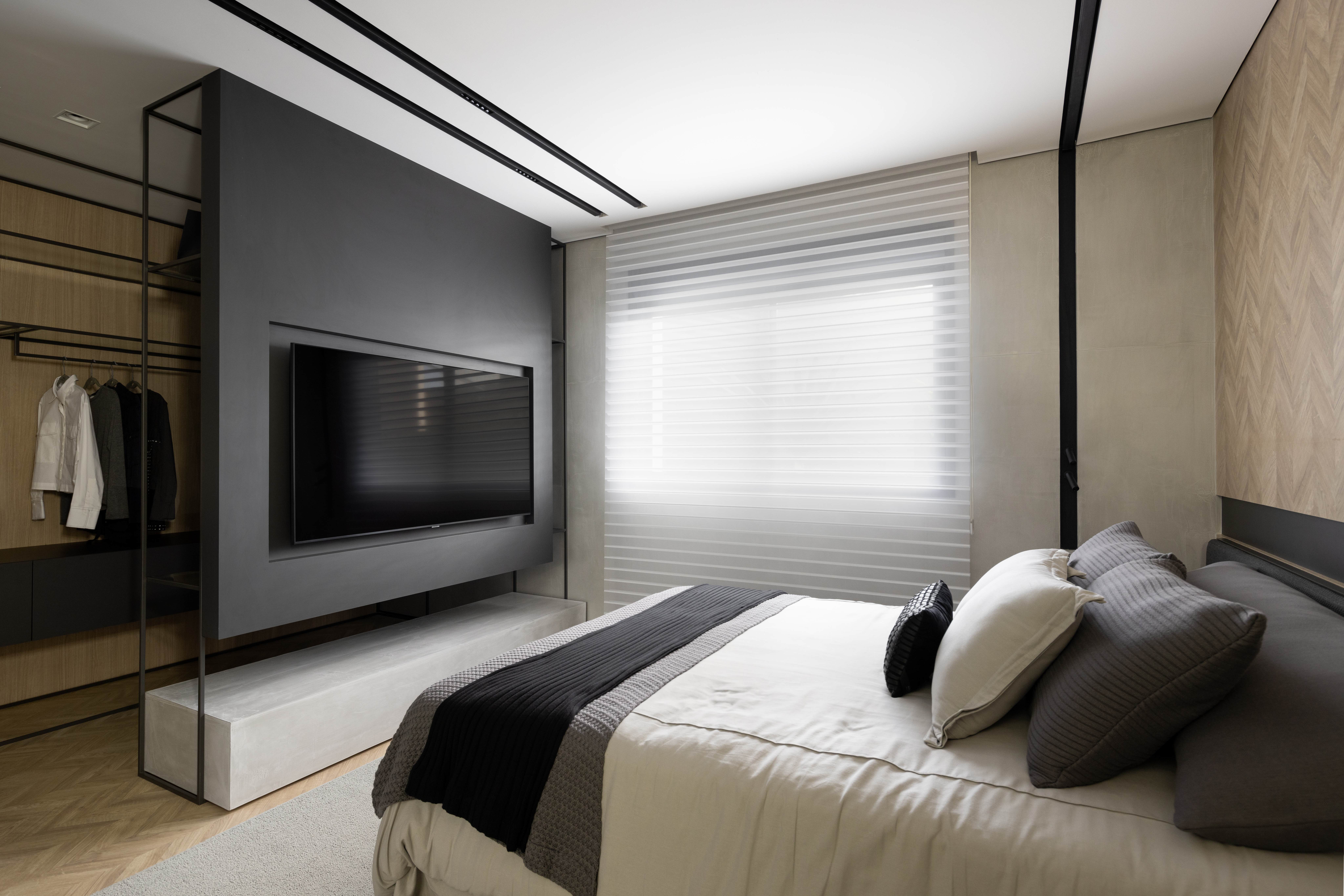 Apê de 142 m² tem paleta elegante de preto e branco e layout integrado. Projeto de Boher Arquitetos. Na foto, quarto de casal com tv e closet, persiana.