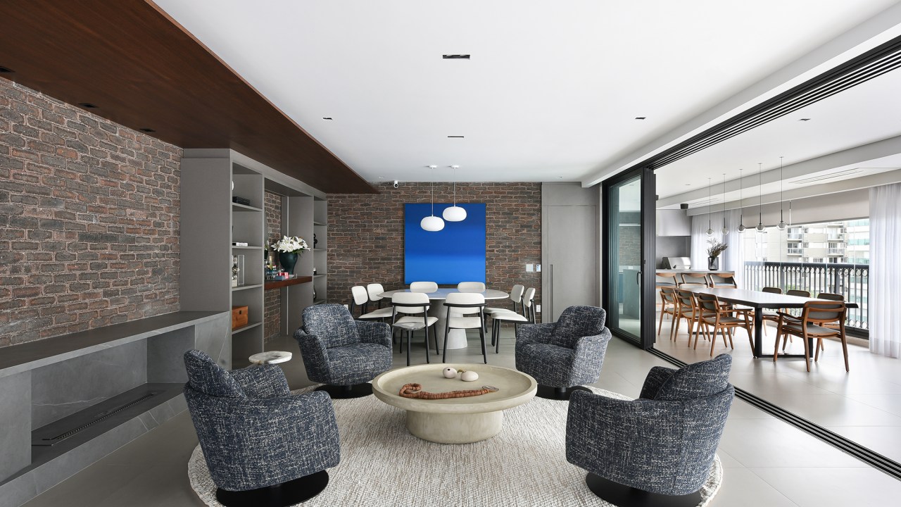 Apê industrial de 360 m² é inspirado nos lofts de Nova York. Projeto de Rebeca Catalucci. Na foto, sala de estar com poltronas. sala de jantar com mesa orgânica.
