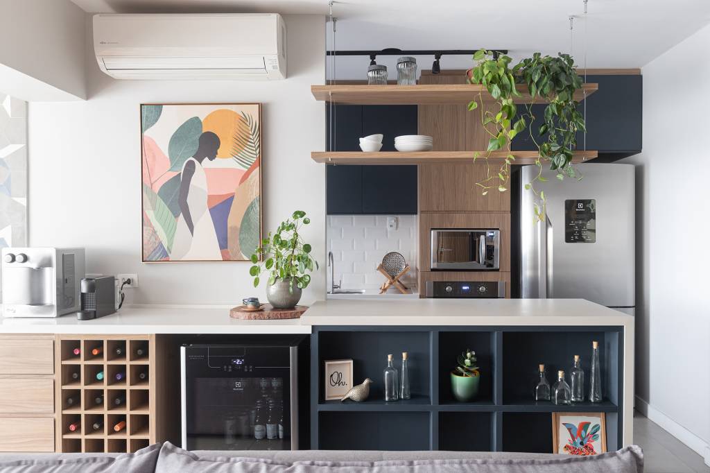 Uma única bancada une área gourmet e cozinha neste apê de 90 m²