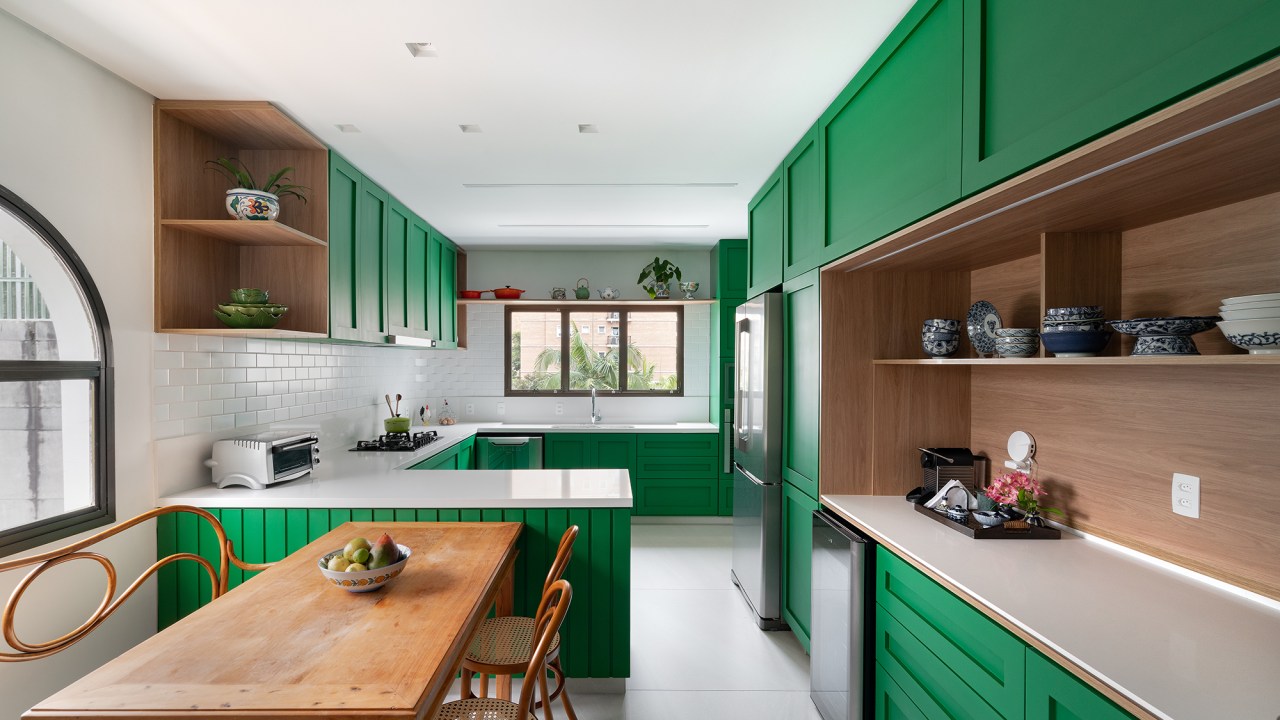 Cozinha verde, lavabo estampado e escorregador dão personalidade a apê. Projeto de Estúdio Pluri. Na foto, cozinha verde com copa e canto do café.