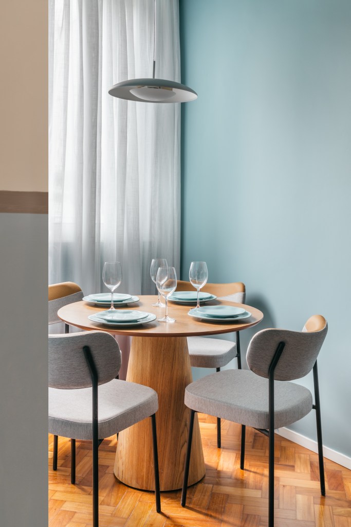 Microapê com 25 m² ganha tons azuis com reforma de apenas 3 meses. Projeto de Rodolfo Consoli. Na foto, sala de jantar pequena com mesa redonda.