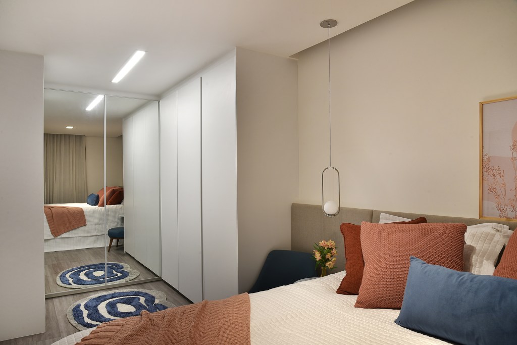 Com apenas 56 m², apartamento ganha décor jovem e descolado. Projeto de Flavia Campos e Sandra Paes. Na foto, quarto de casal com TV e iluminação indireta.