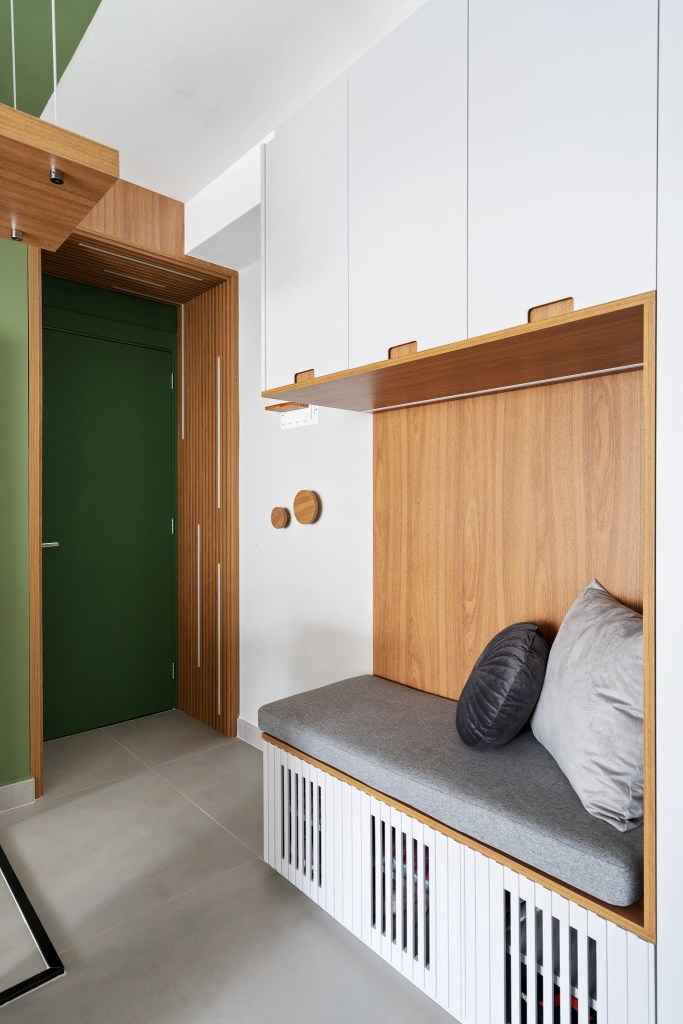 Com circulação otimizada, apê de 49 m² tem tons de verde e madeira. Projeto de Natalia Salla. Na foto, hall de entrada, sapateira, armário branco com banco.