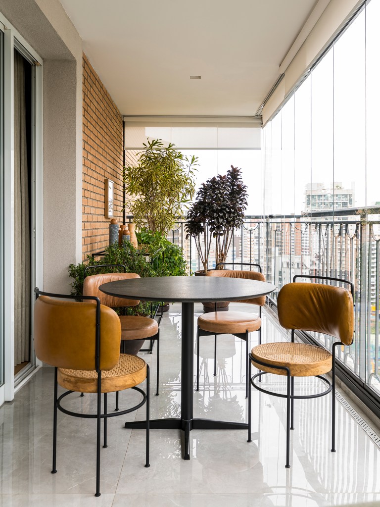 Em um mês, apê alugado de 156 m² ganha projeto contemporâneo e minimalista. Projeto Estúdio Amadas. Na foto, varanda com mesa de refeições e plantas.
