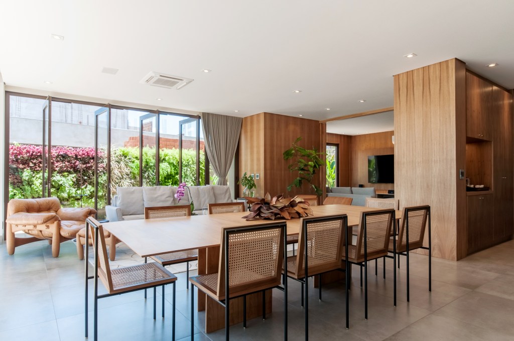 6 tipos de materiais de tampo de mesa para salas de jantar e áreas gourmet. Projeto de Paiva e Passarini Arquitetura. Na foto, sala de jantar com mesa com tampo de madeira.