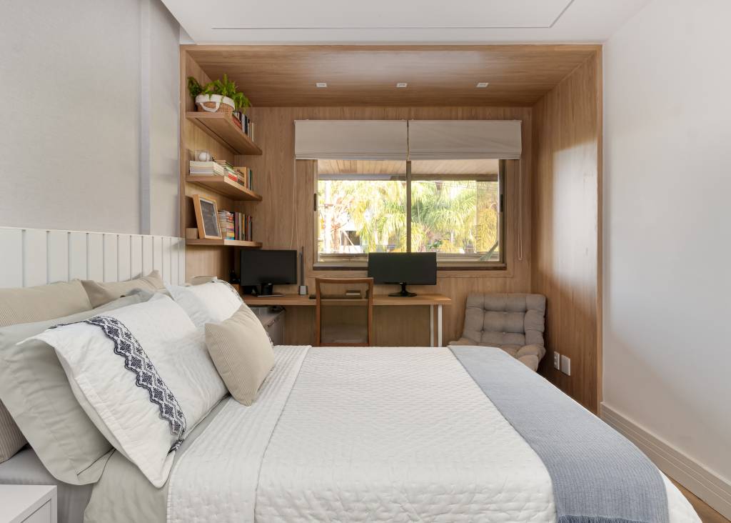 Parede entre sala e cozinha é demolida é dá lugar à cristaleira neste apê. Projeto de MA.DÊ Arquitetura. Na foto, quarto com painéis de madeira e home office.